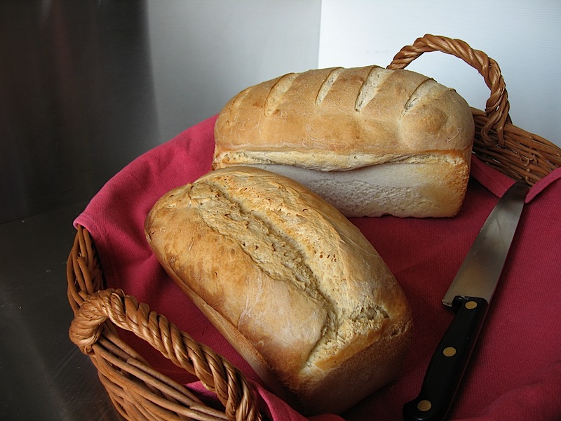 Two loafs of bread raised in tins