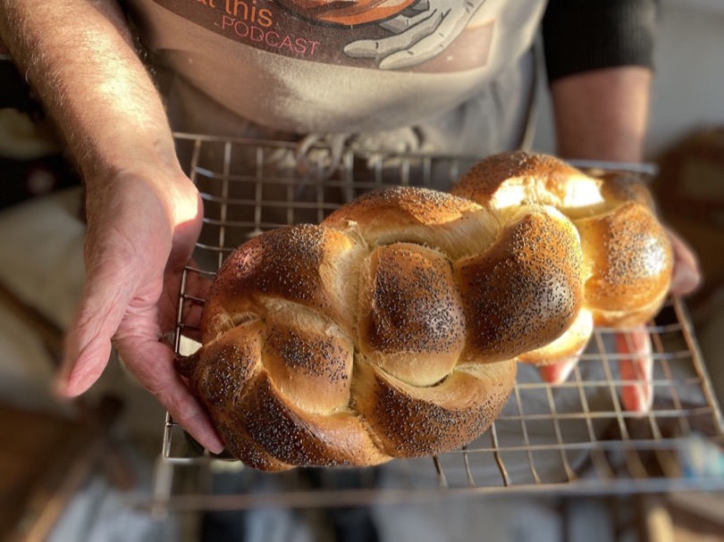 A large challah on a wire rack
