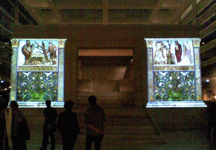 The Ara Pacis monument illuminated by coloured projection.