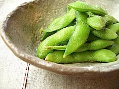 A plate of green edamame soybeans in their pods