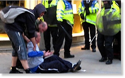 Ian Tomlinson on the ground after attack by UK police