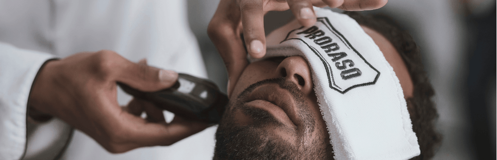 man having his beard trimmed