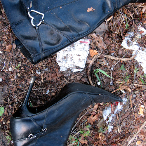 Black stiletto-heeled boot and a handbag