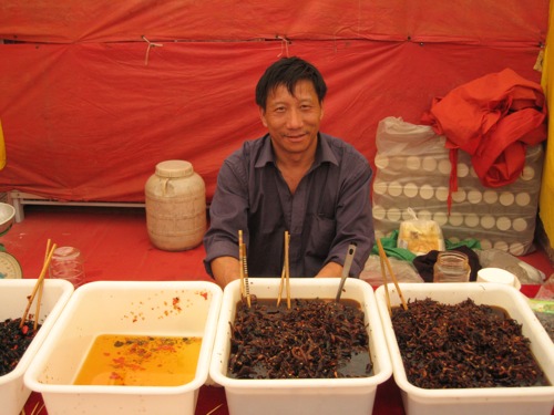 Man at market with chillies