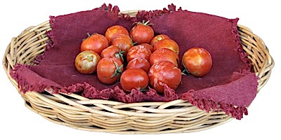 Small tomatoes on a napkin inside a basket