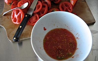 A white bowl containing the gel from inside tomato fruits