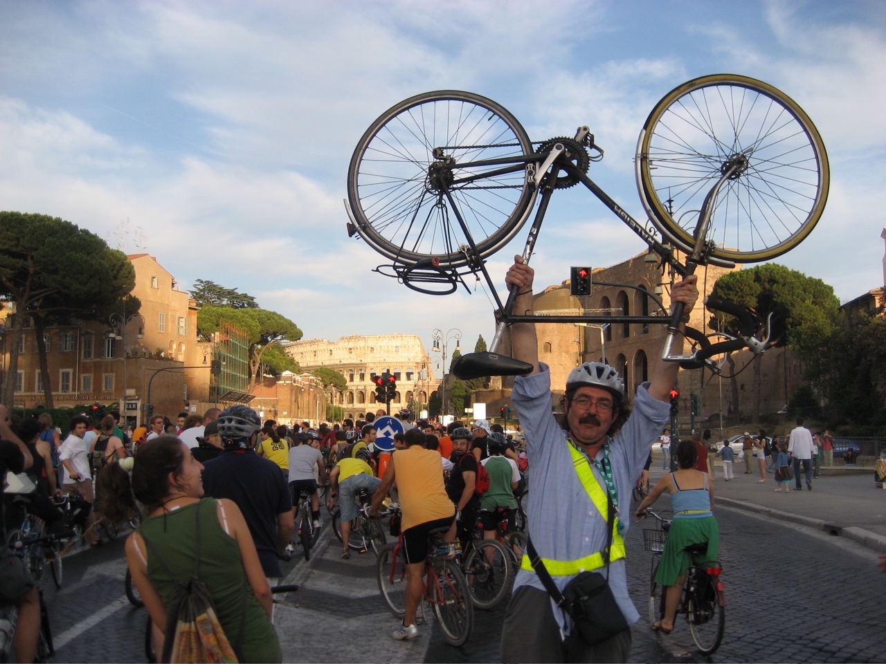 Me holding my bike aloft in front of the Collosseum during a Critical Mass ride