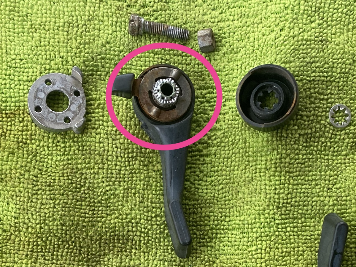 Disassembled index shifter with rusted parts circled