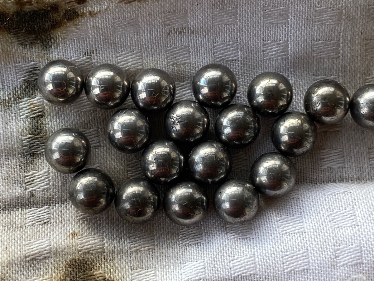 Nineteen ball bearings on a dirty piece of cotton rag